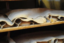 Blonde sourdough loaves proving in linen